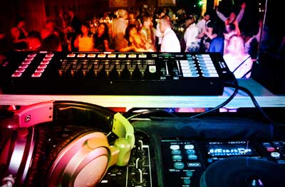 Photo of a mobile disco setup with computer controlled lighting and crowd dancing